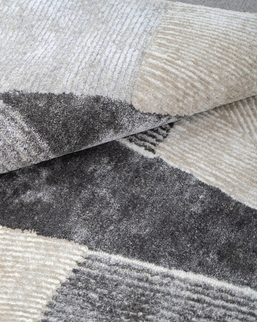 Close-up of the hand-tufted Cava Wool & Silk Rug, showcasing its luxurious wool base and shimmering silk details.